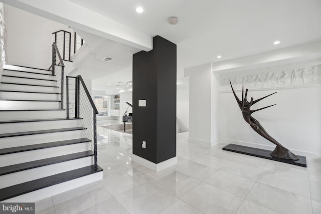 stairs with recessed lighting, visible vents, and baseboards