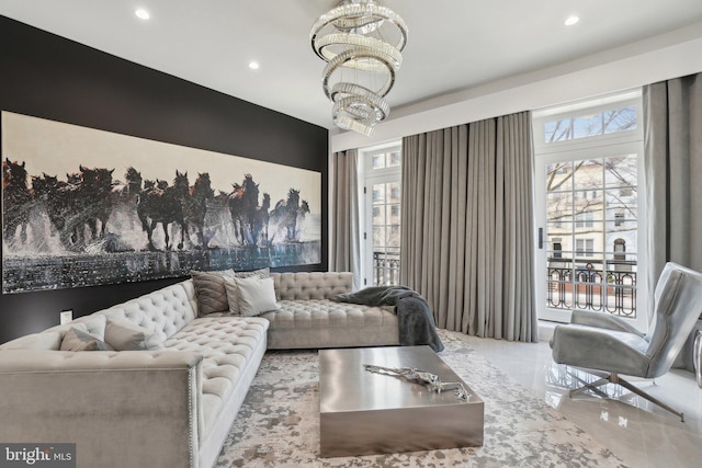 living room featuring recessed lighting and an inviting chandelier