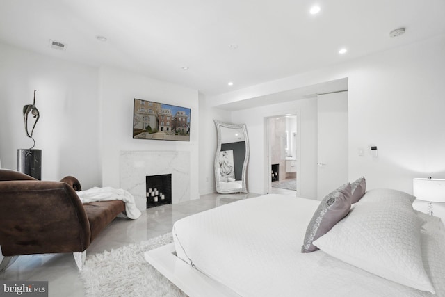 bedroom featuring visible vents, recessed lighting, a fireplace, marble finish floor, and ensuite bath