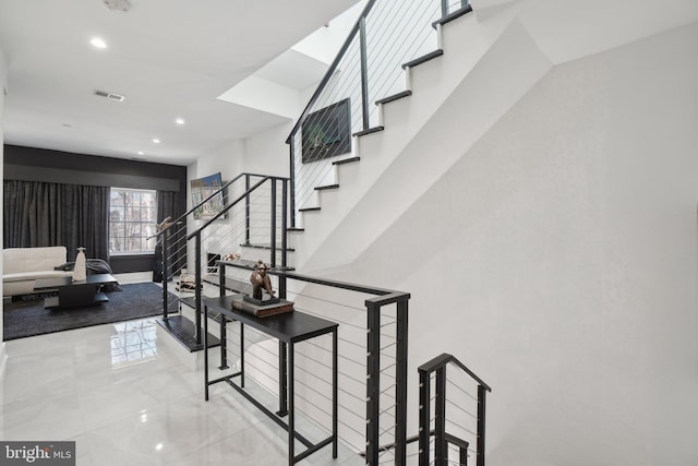 stairway featuring recessed lighting, visible vents, and baseboards