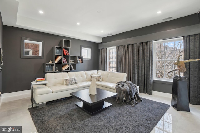 living room featuring recessed lighting, visible vents, and baseboards