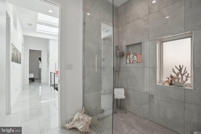 full bathroom with a skylight and walk in shower