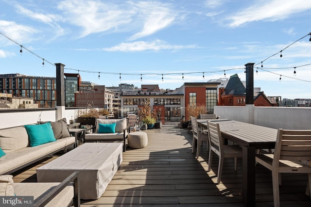 wooden deck featuring outdoor dining area and an outdoor living space