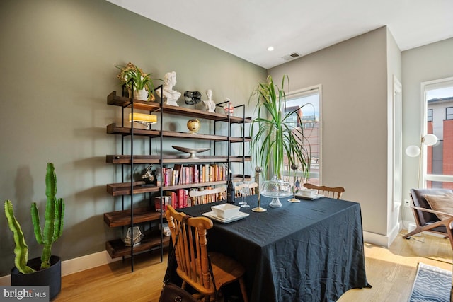 dining room with light wood-type flooring, visible vents, baseboards, and recessed lighting