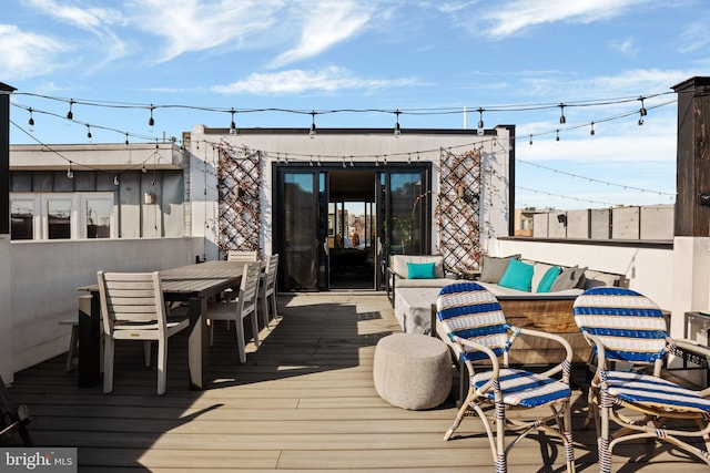 wooden terrace with outdoor dining area