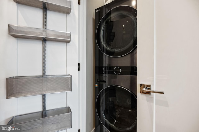 clothes washing area featuring laundry area and stacked washer / drying machine