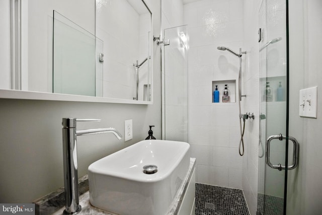 full bathroom featuring a sink and a shower stall