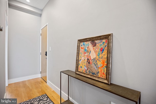 hallway with recessed lighting, wood finished floors, and baseboards