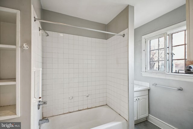 full bathroom with tub / shower combination, vanity, and baseboards