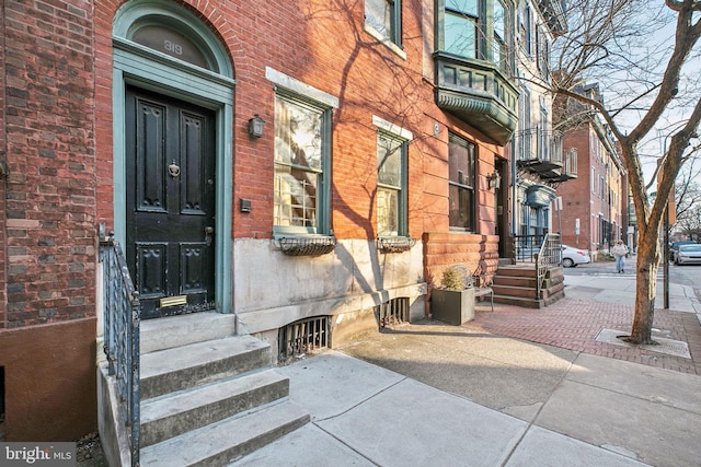 property entrance featuring brick siding