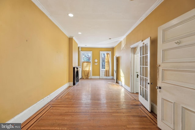 corridor featuring recessed lighting, baseboards, french doors, wood-type flooring, and crown molding