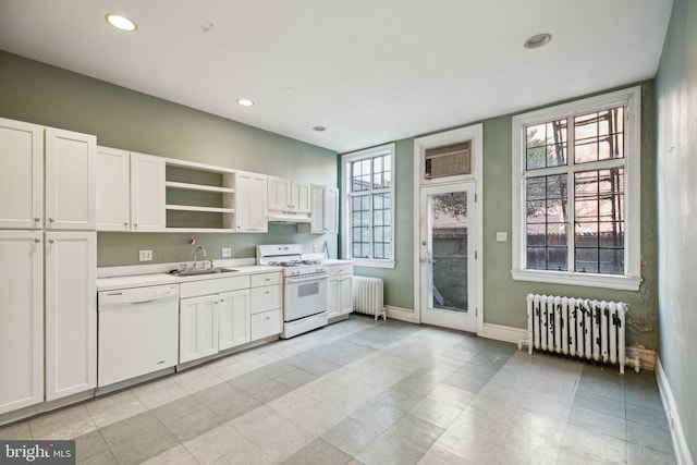 kitchen featuring radiator, white appliances, a sink, and open shelves