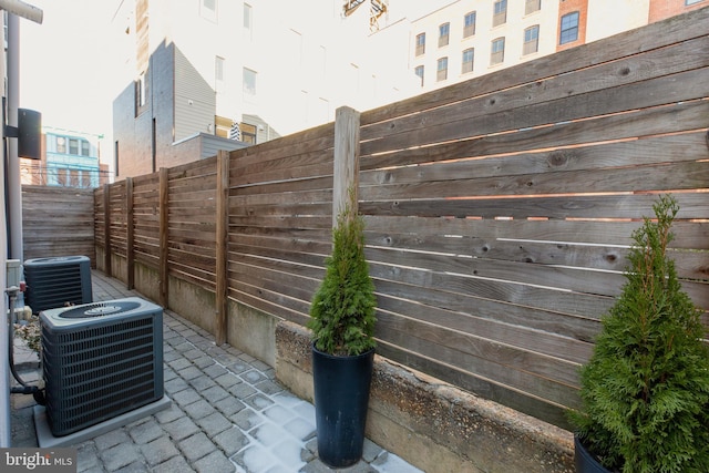 view of patio / terrace featuring a fenced backyard and central air condition unit