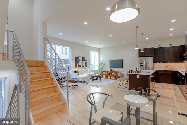 living room with stairs and recessed lighting