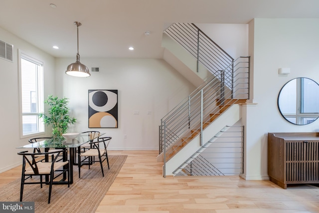 interior space with baseboards, visible vents, radiator heating unit, light wood-style floors, and recessed lighting