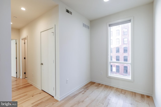 spare room featuring recessed lighting, baseboards, visible vents, and light wood finished floors