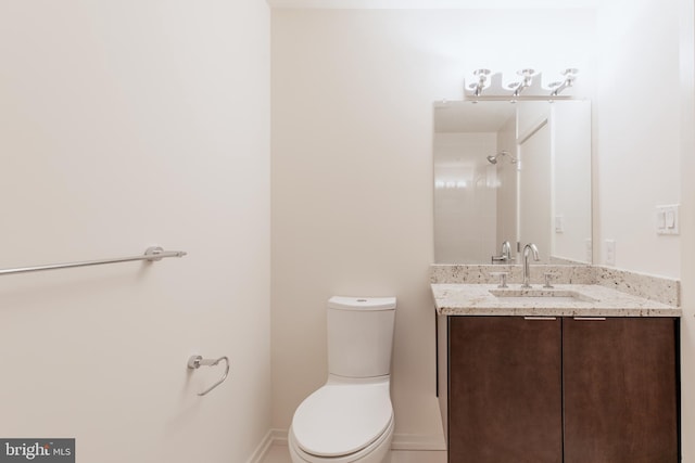 full bathroom featuring walk in shower, vanity, toilet, and baseboards