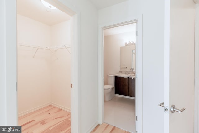 interior space featuring light wood-type flooring and a sink