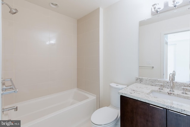 bathroom featuring toilet, bathtub / shower combination, and vanity