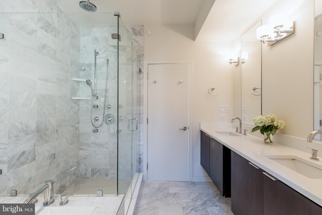 full bathroom featuring marble finish floor, a sink, a shower stall, and double vanity