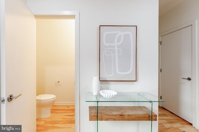 bathroom featuring toilet and wood finished floors