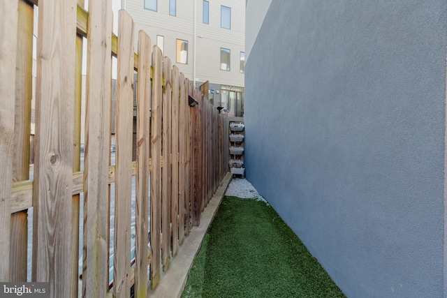 view of side of property featuring fence and stucco siding