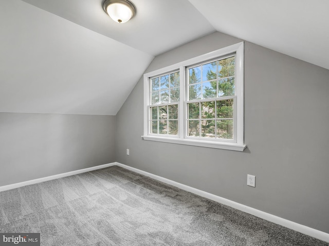 bonus room featuring carpet flooring, vaulted ceiling, and baseboards