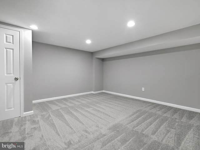 finished below grade area featuring recessed lighting, light carpet, and baseboards