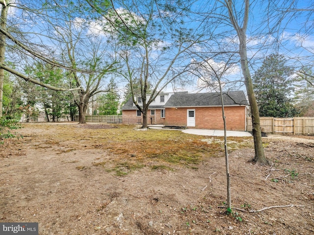 view of yard with fence and a patio