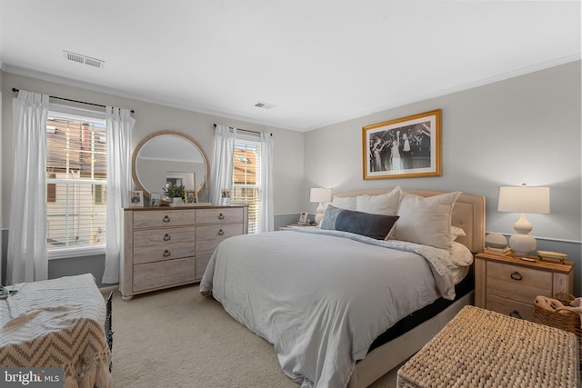 bedroom with light carpet, multiple windows, and visible vents