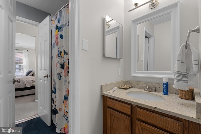 full bath featuring connected bathroom, vanity, and a shower with curtain