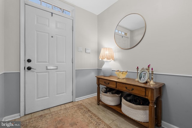 foyer entrance with tile patterned flooring and baseboards