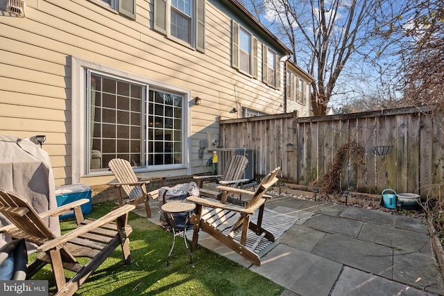 view of patio featuring fence and central air condition unit