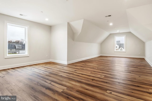 bonus room with baseboards, visible vents, dark wood-style floors, vaulted ceiling, and recessed lighting