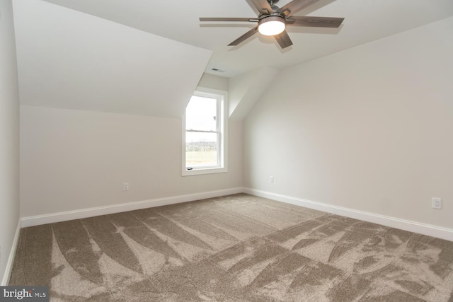 additional living space with ceiling fan, carpet, baseboards, and vaulted ceiling
