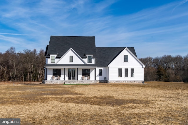 modern farmhouse with a porch and a front lawn
