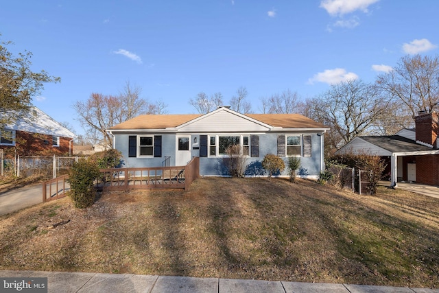 view of front of property with a front lawn and fence