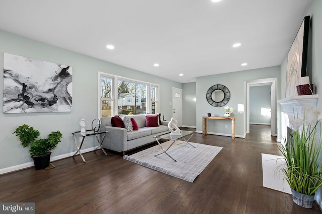 living area with recessed lighting, a fireplace, baseboards, and wood finished floors