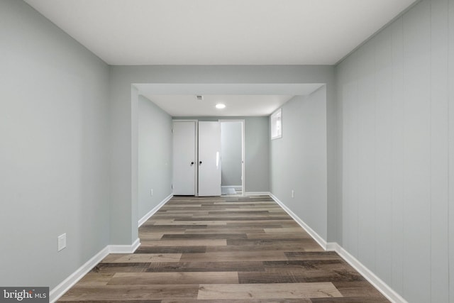 hall featuring baseboards and wood finished floors