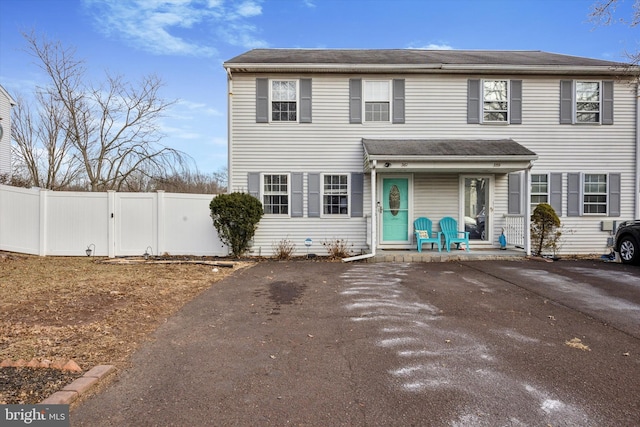 view of front of home featuring a porch, a gate, and fence