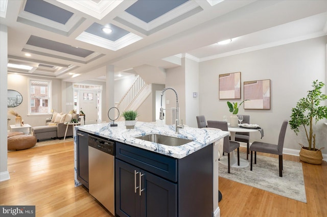 kitchen featuring coffered ceiling, a sink, open floor plan, stainless steel dishwasher, and light wood finished floors