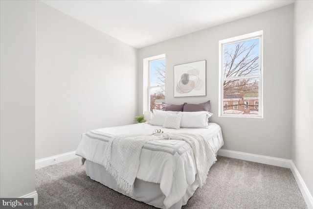 bedroom featuring carpet floors and baseboards