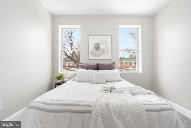 bedroom featuring multiple windows and baseboards