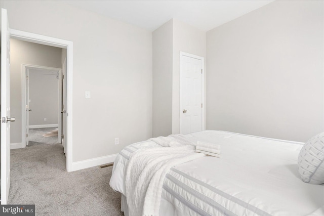 bedroom with carpet floors and baseboards