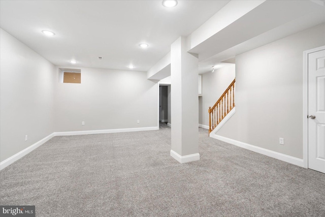 finished basement with stairway, recessed lighting, carpet flooring, and baseboards