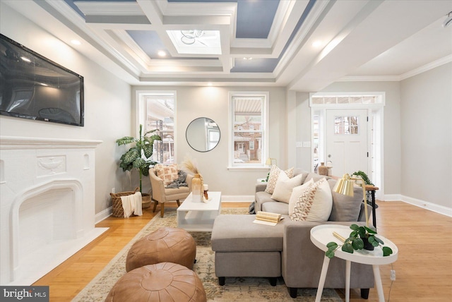 living area featuring coffered ceiling, wood finished floors, and crown molding