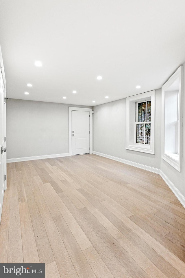 below grade area featuring recessed lighting, light wood-style flooring, and baseboards