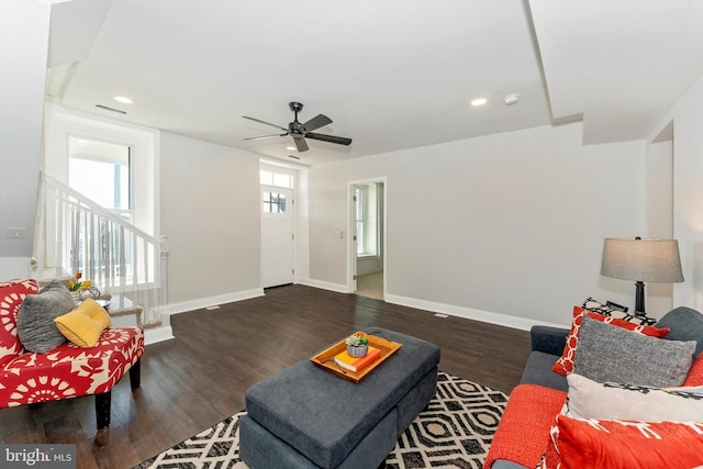 living area featuring stairway, recessed lighting, dark wood finished floors, and baseboards