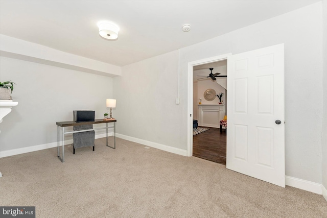 office area featuring baseboards and light colored carpet