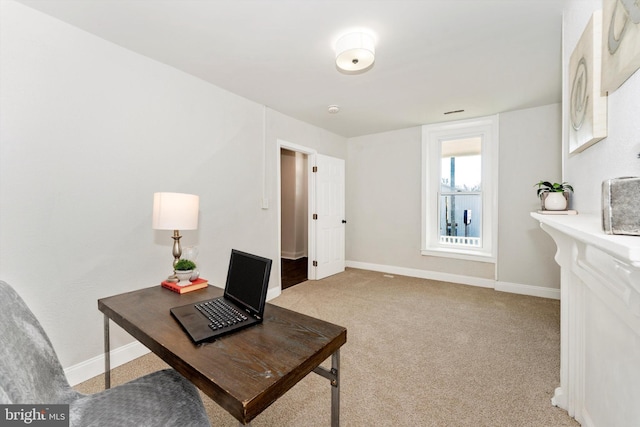 office with light colored carpet and baseboards